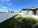 View of backyard with grass, privacy fence and home exterior at 1819 E Chapel Dr, Deltona, FL 32738