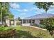 Spacious backyard showcasing the home's screened patio and a charming shed at 1819 E Chapel Dr, Deltona, FL 32738
