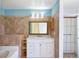 Well-lit bathroom featuring a modern vanity, a large mirror, and a shower, creating a comfortable and functional space at 1819 E Chapel Dr, Deltona, FL 32738