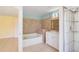 Bathroom features a tub, tiled walls, shower and white vanity at 1819 E Chapel Dr, Deltona, FL 32738