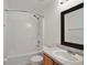 Clean bathroom with a tub and shower combination, and a vanity with a framed mirror at 1819 E Chapel Dr, Deltona, FL 32738