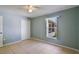 Bright bedroom featuring a ceiling fan, tile floors, and a window for natural light at 1819 E Chapel Dr, Deltona, FL 32738