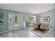 The dining room features neutral walls, tile flooring, chandelier and a view of the front yard at 1819 E Chapel Dr, Deltona, FL 32738