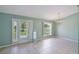The dining room features neutral walls, tile flooring, chandelier and a view of the front yard at 1819 E Chapel Dr, Deltona, FL 32738