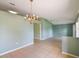 Open dining area highlighted by a classic chandelier and tile floors, creating an inviting atmosphere for gatherings at 1819 E Chapel Dr, Deltona, FL 32738
