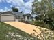 Inviting home with large driveway, lush landscaping, and a classic white picket fence at 1819 E Chapel Dr, Deltona, FL 32738