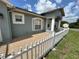 Charming home featuring a tiled porch, white picket fence, and light blue exterior at 1819 E Chapel Dr, Deltona, FL 32738
