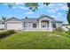Charming single-story home with a well-manicured lawn and a white picket fence at 1819 E Chapel Dr, Deltona, FL 32738