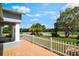Front porch with orange tile, white pickett fence with a green yard and palm trees in view at 1819 E Chapel Dr, Deltona, FL 32738