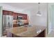 Beautiful kitchen featuring granite counters, stainless appliances, and dark wood cabinetry at 1819 E Chapel Dr, Deltona, FL 32738