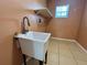 Laundry room featuring utility sink with faucet and tile floor at 1819 E Chapel Dr, Deltona, FL 32738