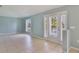Open living space boasting tile flooring, large window for natural light, and sliding glass door access to the balcony at 1819 E Chapel Dr, Deltona, FL 32738