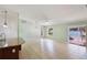 Bright open-concept area showcasing tile floors and sliding door access to the patio at 1819 E Chapel Dr, Deltona, FL 32738