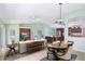 Bright living room open to kitchen and dining area, features neutral walls, tile flooring at 1819 E Chapel Dr, Deltona, FL 32738