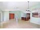 Spacious living room open to kitchen, featuring neutral walls, and tile flooring at 1819 E Chapel Dr, Deltona, FL 32738