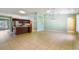 Spacious open-concept featuring tile floors and a kitchen with modern stainless steel appliances at 1819 E Chapel Dr, Deltona, FL 32738