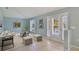 Bright living room featuring neutral tones and tile flooring with a large sliding glass door to the outdoor space at 1819 E Chapel Dr, Deltona, FL 32738