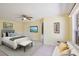 Comfortable main bedroom featuring warm yellow walls, a ceiling fan, and a TV, creating a relaxing retreat at 1819 E Chapel Dr, Deltona, FL 32738