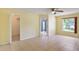 Main bedroom featuring tile floors, natural lighting, and access to a private bathroom and walk-in closet at 1819 E Chapel Dr, Deltona, FL 32738