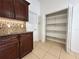 Kitchen with pantry, cabinets, granite counter tops and tile backsplash at 1819 E Chapel Dr, Deltona, FL 32738