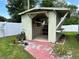Backyard shed surrounded by grass, plants, and a privacy fence at 1819 E Chapel Dr, Deltona, FL 32738