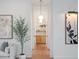 Hallway features hardwood floors and unique modern light fixture at 9508 Sloane St, Orlando, FL 32827