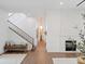 Bright living room featuring a fireplace, stairway and hardwood floors at 9508 Sloane St, Orlando, FL 32827