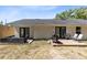 Enjoy the backyard featuring a built-in hot tub, wooden deck for grilling, and a spacious grassy area at 132 Alachua Dr, Winter Haven, FL 33884