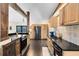 Well-appointed kitchen with stainless appliances, dark countertops, and custom cabinetry at 132 Alachua Dr, Winter Haven, FL 33884