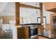 Open kitchen view with dark hardwood floors, stainless appliances, and breakfast bar at 132 Alachua Dr, Winter Haven, FL 33884