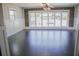 Spacious living room featuring dark wood floors and a large window with ample natural light at 132 Alachua Dr, Winter Haven, FL 33884