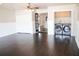 Bright living room with dark wood floors, laundry area, and a doorway leading to another room at 132 Alachua Dr, Winter Haven, FL 33884