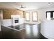 Open living room featuring a decorative wood accent wall, fireplace, and hardwood floors at 132 Alachua Dr, Winter Haven, FL 33884