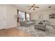 Bright living room featuring a large sectional sofa, area rug, ceiling fan, and neutral decor at 1432 Meadowlark Dr, Deltona, FL 32725