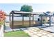 Large backyard with covered outdoor patio including stone pavers, small synthetic grass, and a gazebo at 184 Lake Smart Cir, Winter Haven, FL 33881
