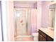 Bathroom featuring a shower with patterned glass, lavendar walls, and a dark vanity at 184 Lake Smart Cir, Winter Haven, FL 33881