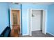 Blue bedroom with carpet, closet, and attached bathroom at 184 Lake Smart Cir, Winter Haven, FL 33881