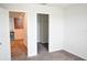 An empty bedroom featuring neutral carpet, closet, and a doorway leading to the loft at 184 Lake Smart Cir, Winter Haven, FL 33881