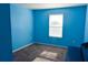 Small blue bedroom with neutral carpet at 184 Lake Smart Cir, Winter Haven, FL 33881