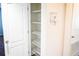 A white closet with metal shelves and access to storage space at 184 Lake Smart Cir, Winter Haven, FL 33881
