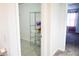 Bright hallway with a wire shelving unit, tile, and a view to a bedroom at 184 Lake Smart Cir, Winter Haven, FL 33881