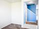 An interior view featuring neutral carpet, neutral paint and a bright blue accent wall near the stairs at 184 Lake Smart Cir, Winter Haven, FL 33881