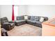 Cozy living room with a gray sectional sofa, recliner and neutral carpet at 184 Lake Smart Cir, Winter Haven, FL 33881