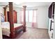 Bedroom featuring neutral carpet, furniture, and a window with curtains at 184 Lake Smart Cir, Winter Haven, FL 33881