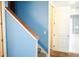Staircase features carpeted steps and a light brown wooden handrail at 184 Lake Smart Cir, Winter Haven, FL 33881