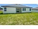 View of the home exterior showing a covered patio and backyard at 4295 Nw 1St Court Rd, Ocala, FL 34475