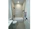 Modern bathroom with white tub, tiled walls, and black fixtures at 4295 Nw 1St Court Rd, Ocala, FL 34475