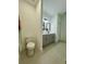 Bathroom with toilet area and stylish vanity with gray cabinets and modern fixtures at 4295 Nw 1St Court Rd, Ocala, FL 34475