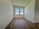 Well-lit bedroom with luxury vinyl flooring and two large windows at 4295 Nw 1St Court Rd, Ocala, FL 34475