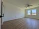 Spacious bedroom with luxury vinyl floors, large windows, and modern sliding door at 4295 Nw 1St Court Rd, Ocala, FL 34475